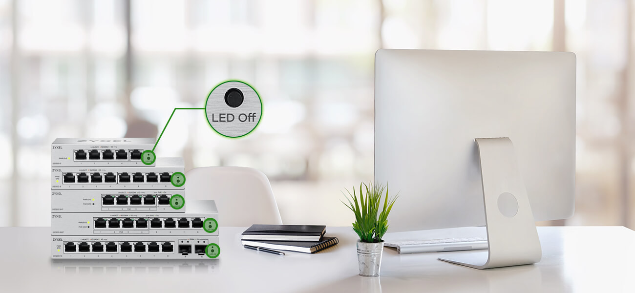 A quiet office scenario where a stack of switches highlights the Noiseless, Disturbance-Free Design via the LED Off function.