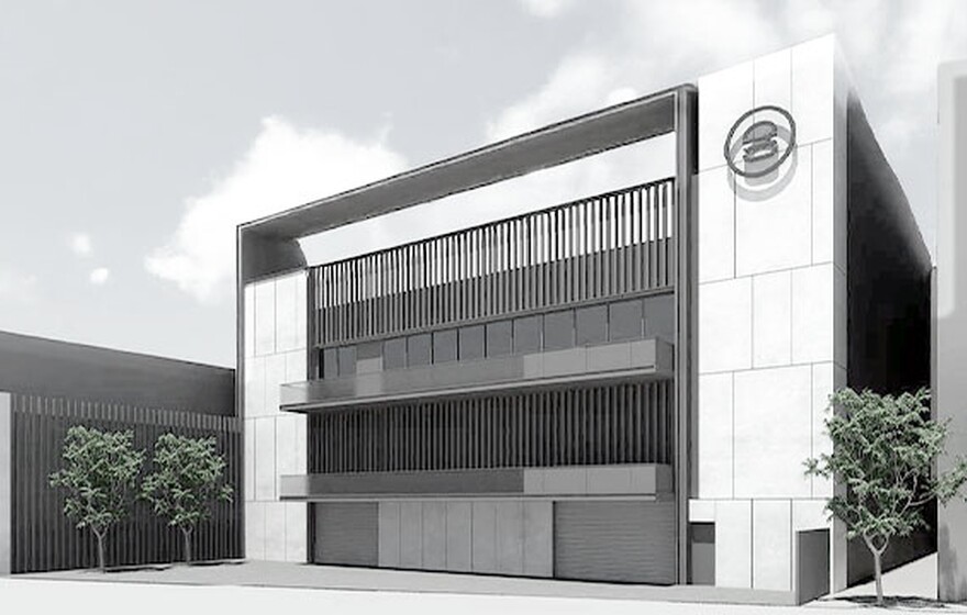 City Burger corporate office building exterior with modern minimalist design, glass windows, vertical slats, and trees.