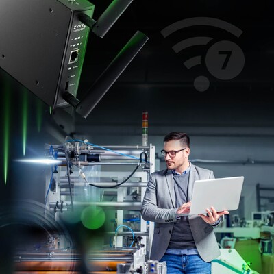 A man operates a laptop in a factory, representing Zyxel's commitment to enhancing industrial automation showcased at FITAG.