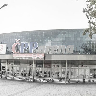A panoramic photo of the CPP arena entrance in Czech, a large building with a blue glass facade and the name in red and white.