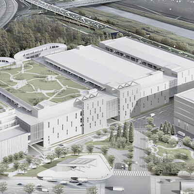 Zyxel Networks case study: Aerial view of a modern logistics complex with a large green rooftop park next to a highway.