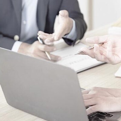 Case study: Lawyers at a desk with a laptop and scales of justice, featuring Zyxel Networks Nebula solution for a law firm.