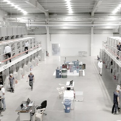 Workers operate large-scale printing and packaging machines inside a modern India Printing & Packaging factory  