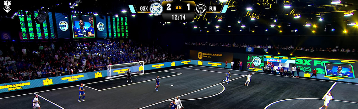 Players compete in a fast-paced Kings League Brazil match as spectators watch and digital screens enhance the immersive indoor arena experience.