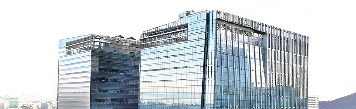Two modern glass skyscrapers with reflective blue windows stand tall against a bright city skyline background.