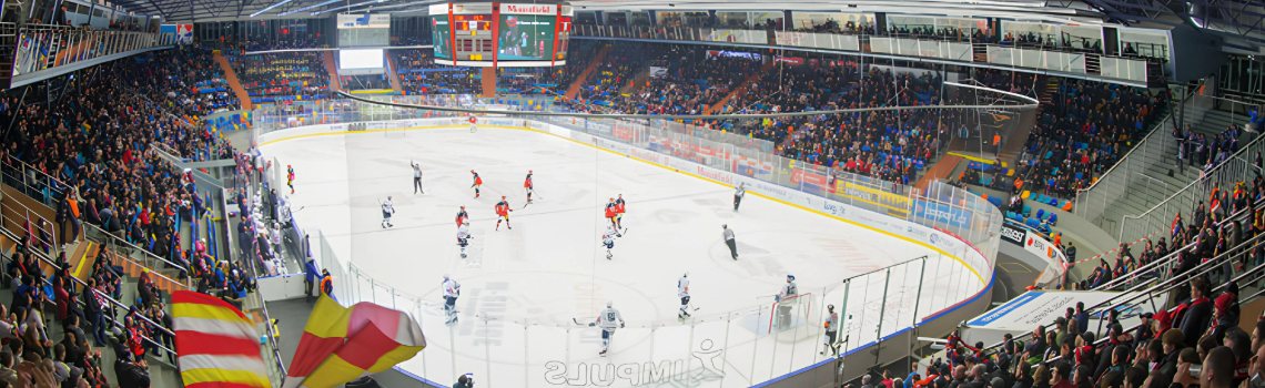 A panoramic photo of the CPP arena entrance in Czech, a large building with a blue glass facade and the name in red and white.