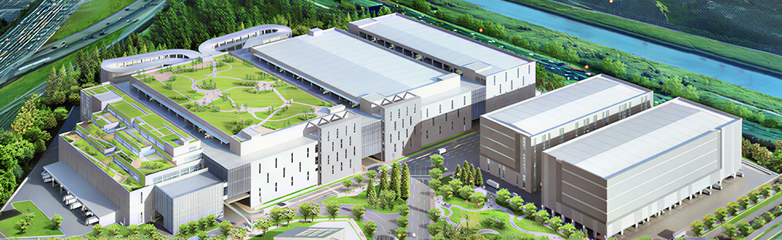 Zyxel Networks case study: Aerial view of a modern logistics complex with a large green rooftop park next to a highway. 
