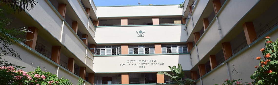 Front view of City College South Calcutta Branch building, showing a three-floor structure surrounded by greenery and flowering plants.